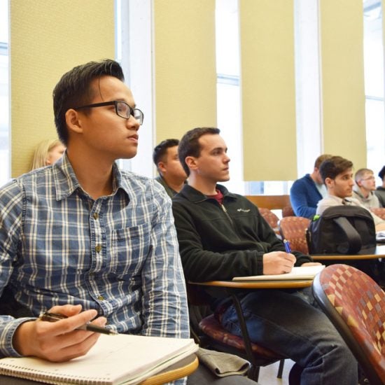 students sitting at desks in a classroom