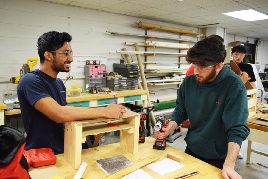 two students building a wooden prototype