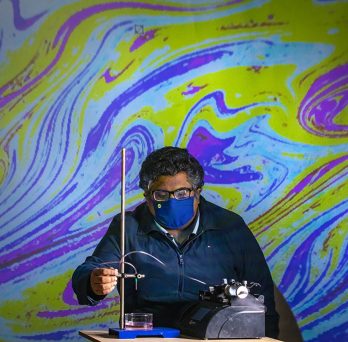 Varun Kulkarni, a post-doc researcher at UIC, investigating oil droplets in water 