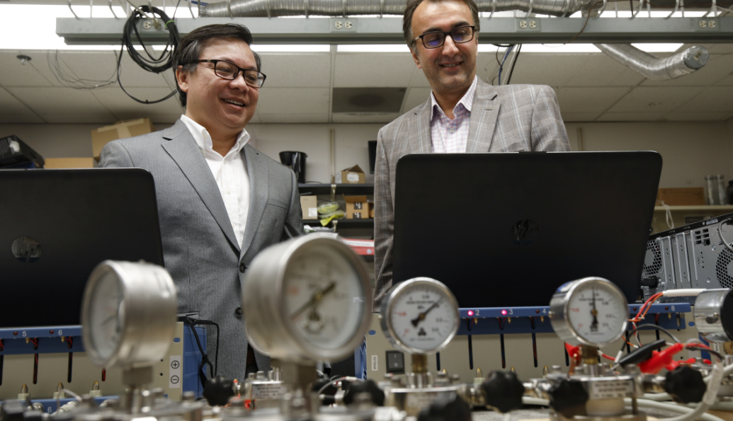University of Illinois Chicago College of Engineering ChE professors Amin Saleh-Khojin (right) and Anh Ngo in their Li-air batteries lab.